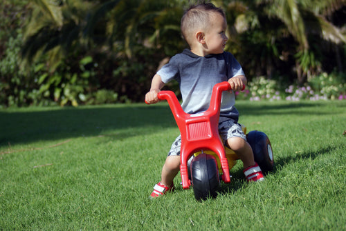 Toddler riding Tri-ang A.T. Cycle 
